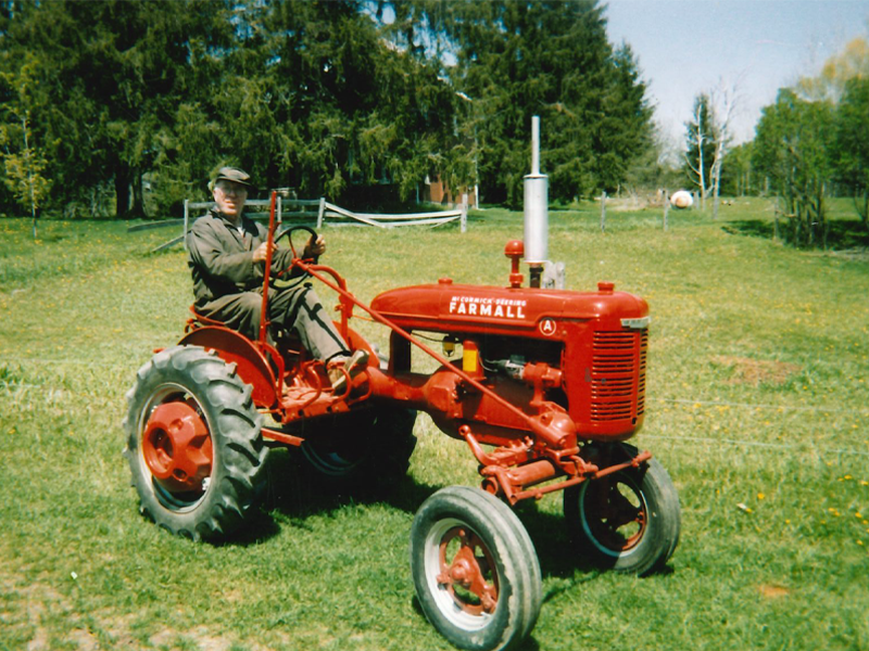 Photo: Edgar Reinhart riding a tractor