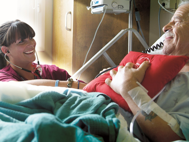 St. Mary's staff member with cardiac patient.